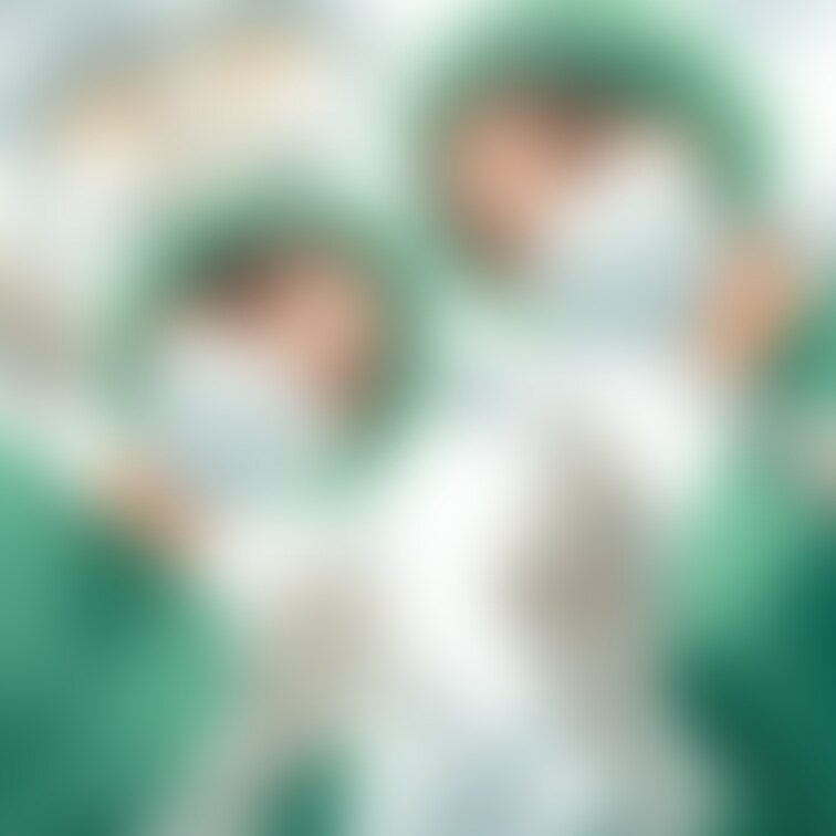 緑の手術ガウンを着た歯科女医と歯科衛生士